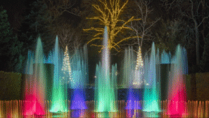 Colorful illuminated fountain at Herbein's Garden Center during evening.