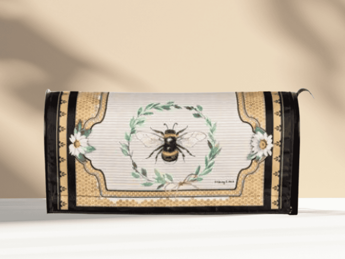 Decorative bee-themed mailbox for gardens or outdoor spaces.