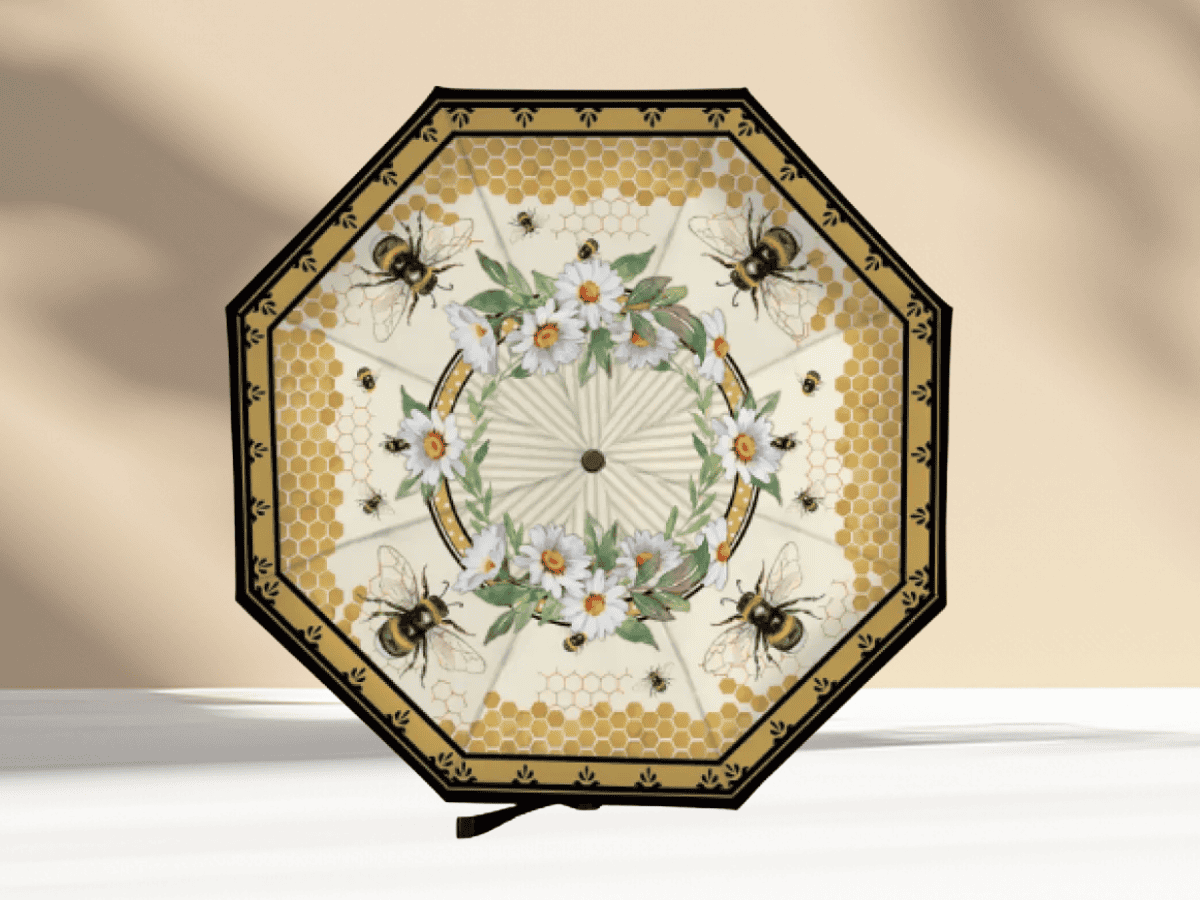Decorative umbrella featuring bees, honeycomb patterns, and floral design for garden or outdoor use.