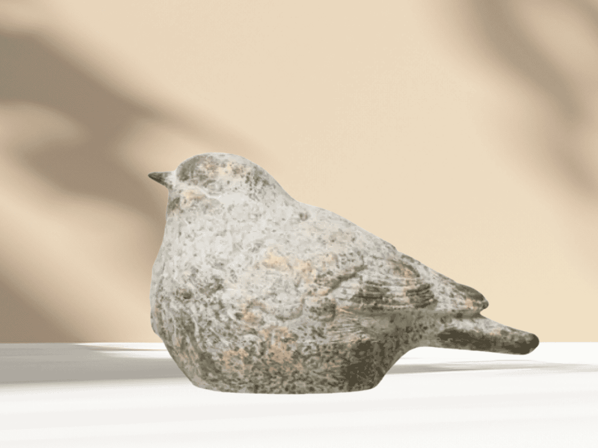 Decorative stone bird sculpture perfect for garden or yard accents.