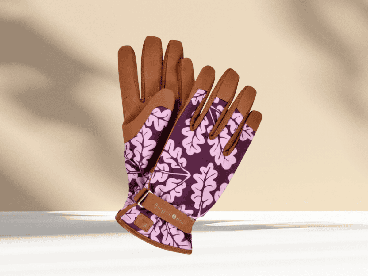 Stylish garden gloves with brown leather and purple leaf pattern, perfect for gardening activities and outdoor work.
