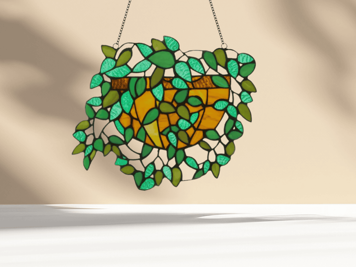 Colorful stained glass heart with green and amber shades, decorative hanging piece.