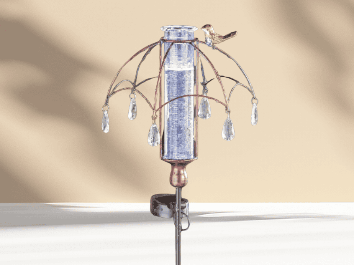 Decorative glass and metal wind chime with hanging crystal accents, perfect for garden and backyard ambiance.