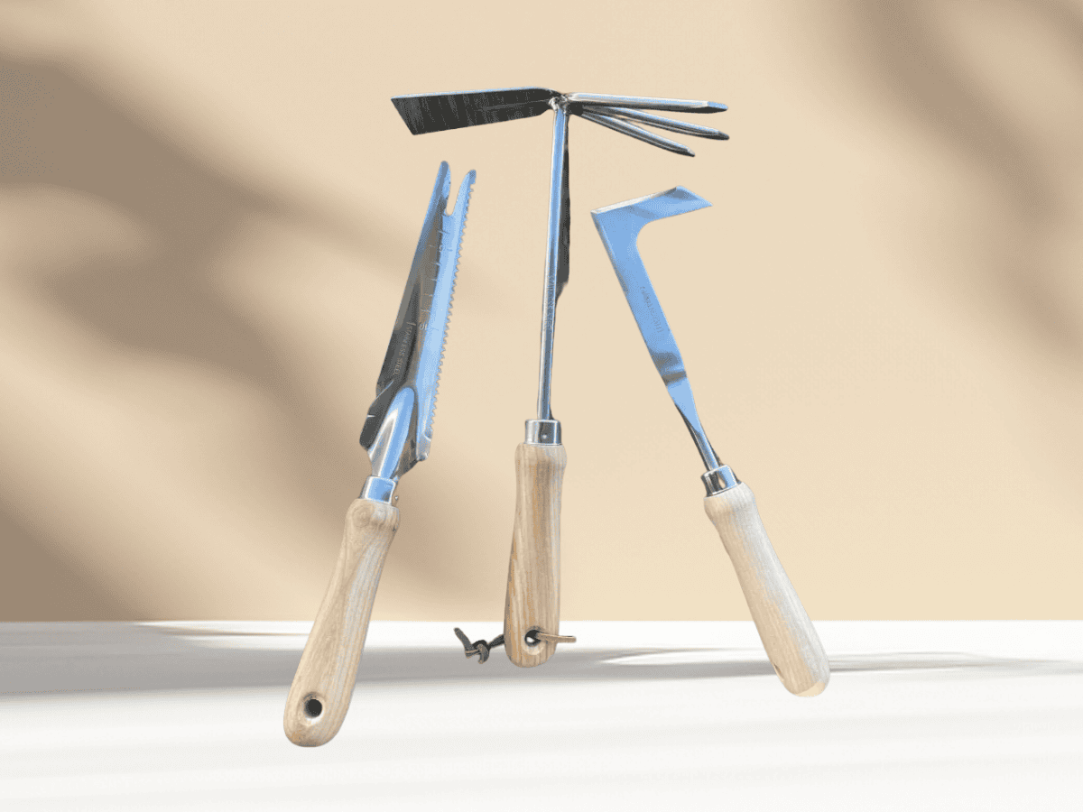 Garden pruning tools, including shears and a hand rake, ideal for plant trimming and maintenance.